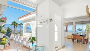 A modern living room with a large sliding glass door leading to a balcony with a view of the mountains. - Private Garden & pool, Sea View, near restaurant, free Wi-fi, 5,5 km from Beach (La Matanza de Acentejo)