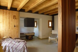 A room with wooden beams, a bed, a chair, and a small table. - Kaletheia house - restored mill (Volpago del Montello (TV))