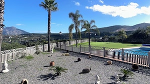 A pool area with a view of mountains, surrounded by palm trees and a fence. - Finca, Villa, Large HEATED Private Pool fantastic views, secluded near Coin (Coín)