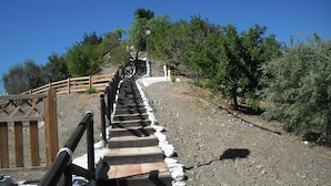 A wooden staircase leading uphill with a metal railing, surrounded by trees and a clear sky. - Finca, Villa, Large HEATED Private Pool fantastic views, secluded near Coin (Coín)