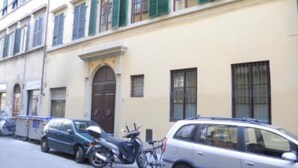 A row of parked cars and a motorcycle along a street with buildings featuring arched windows and shutters. - apartment in Santa Croce 52 in Florence ( Italy) (Firenze)