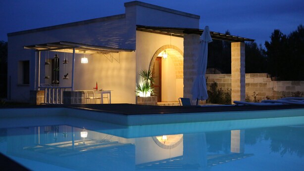 A modern house with a swimming pool, outdoor seating, and a well-lit patio area. - HOUSE WITH GARDEN AND SWIMMING POOL FOR EXCLUSIVE USE IN SALENTO, OTRANTO, LECCE (corigliano d' otranto)