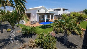 A modern house with a patio, outdoor seating, and a pool. - Luxury villa, heat pool ,ecological, chlorine-free  ,Jacutzzi / bicycl (Yaiza)