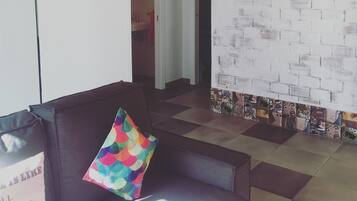 Relax in a cozy seating area with a comfortable sofa and eclectic decor.