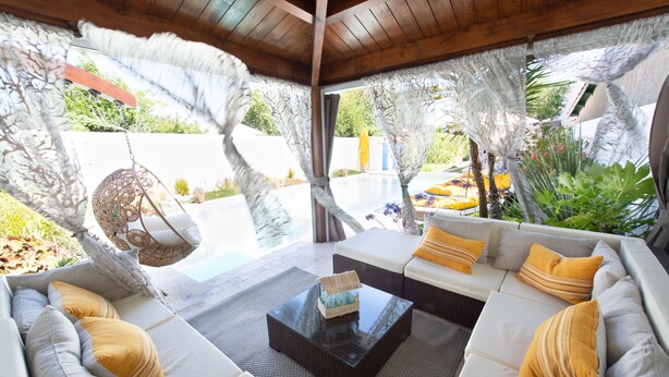 A modern living room with a sofa set, a hanging chair, and a coffee table. - Holiday home, Ile d'Oléron 'L'Eglade' 4 star rating * * * * (Le Grand-Village-Plage)