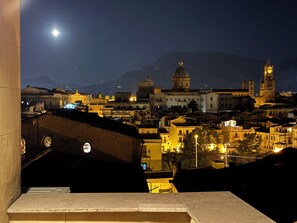 A nighttime view of a cityscape with illuminated buildings and a prominent church dome. - Historic center, 2 rooms, 2 toilets, sky terrace, lift, free high speed Wi Fi (PALERMO)