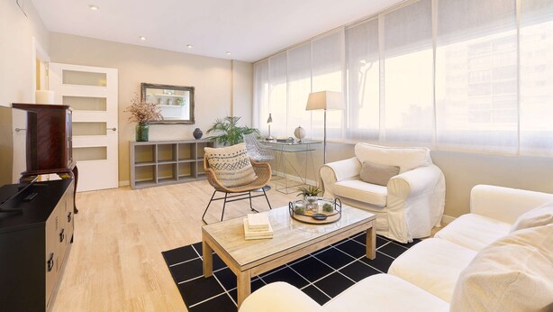 A modern living room with a sofa, armchairs, a coffee table, and a TV stand. - Property with parking, Ac,wifi, metro & at only 8 min.from city centre by metro. (Barcelona)
