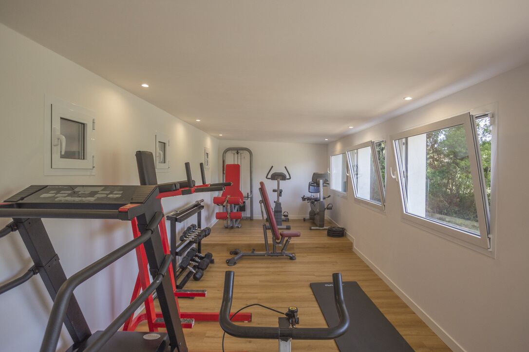 A gym with treadmills, weight machines, and benches.