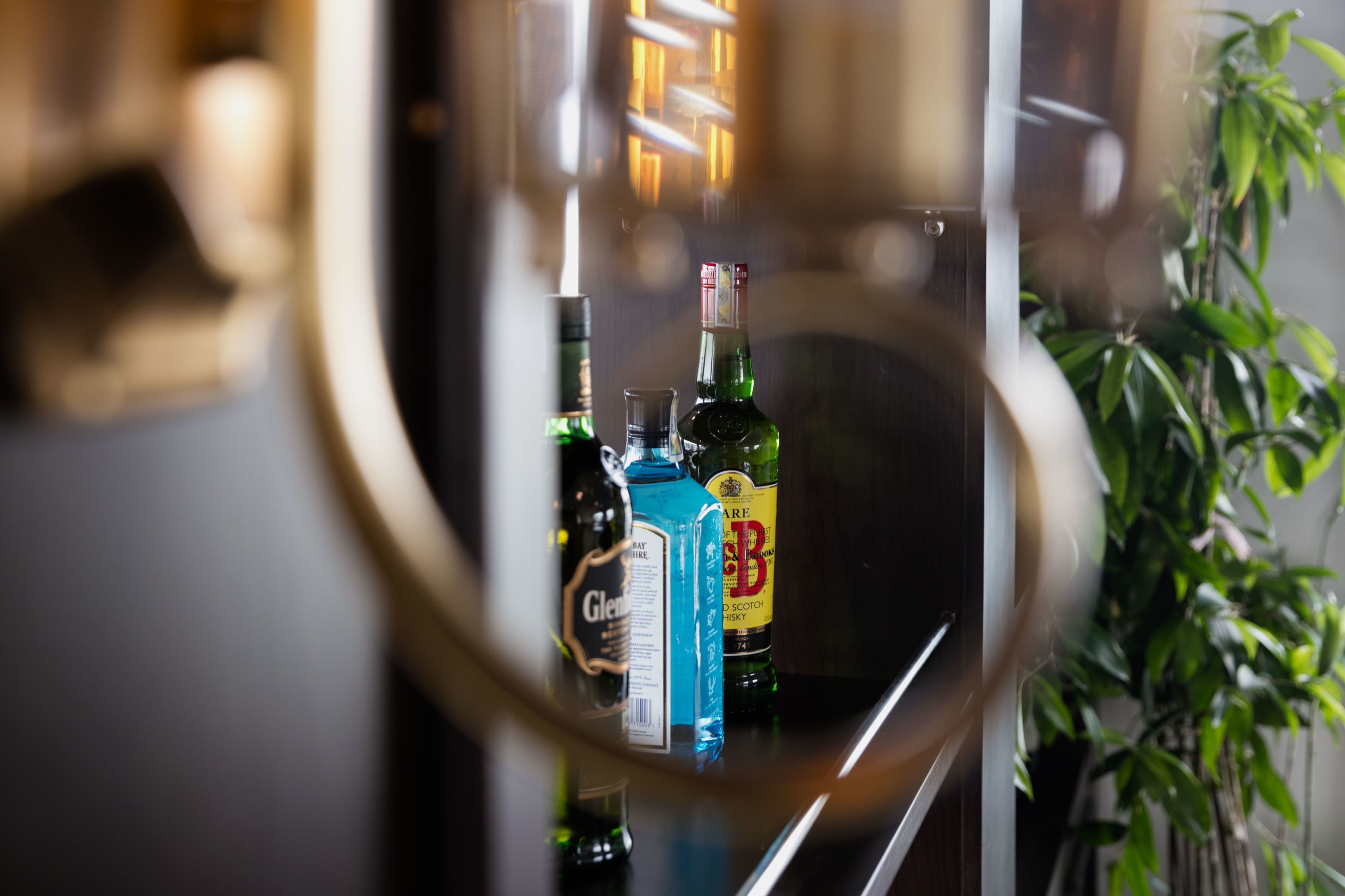 A bar area with various bottles and a glass.
