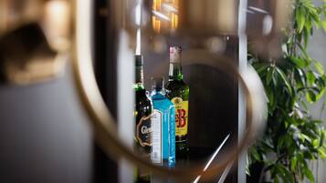 A bar area with various bottles and a glass.
