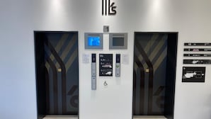 An elevator with a digital display, floor guide, and emergency instructions. - Y’s Hotel Shin - Osaka (Osaka)