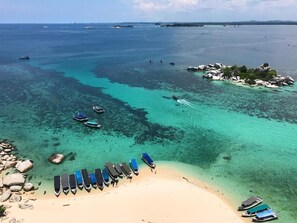 Beach nearby, white sand, beach umbrellas, beach towels