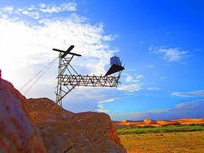 A power line tower with a large metal structure attached to it. - Alternative Space B & B (Swakopmund)