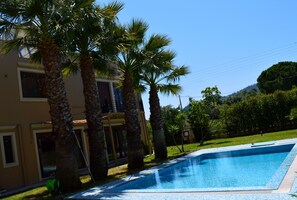 Piscine extérieure, parasols de plage, chaises longues