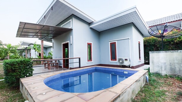 A modern house with a swimming pool, a covered patio, and a satellite dish. - OYO 690 Bann Supansa Resort (Krabi)