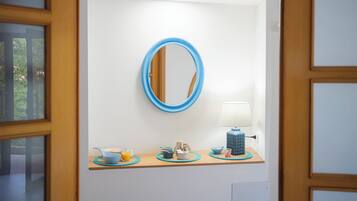 A bathroom with a mirror, a sink, and a towel rack.