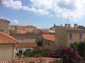 A view of a town with terracotta-roofed buildings, stone walls, and a clear sky. - 20m2 fully renovated Studio with Private Balcony, rates are All Inclusive. (Antibes)