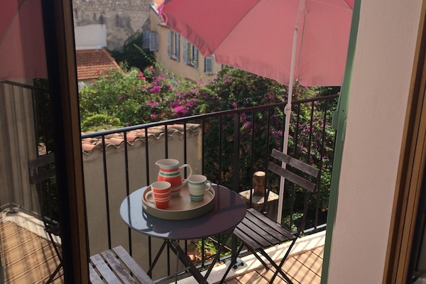 south facing balcony with folding table umbrella and small loungers