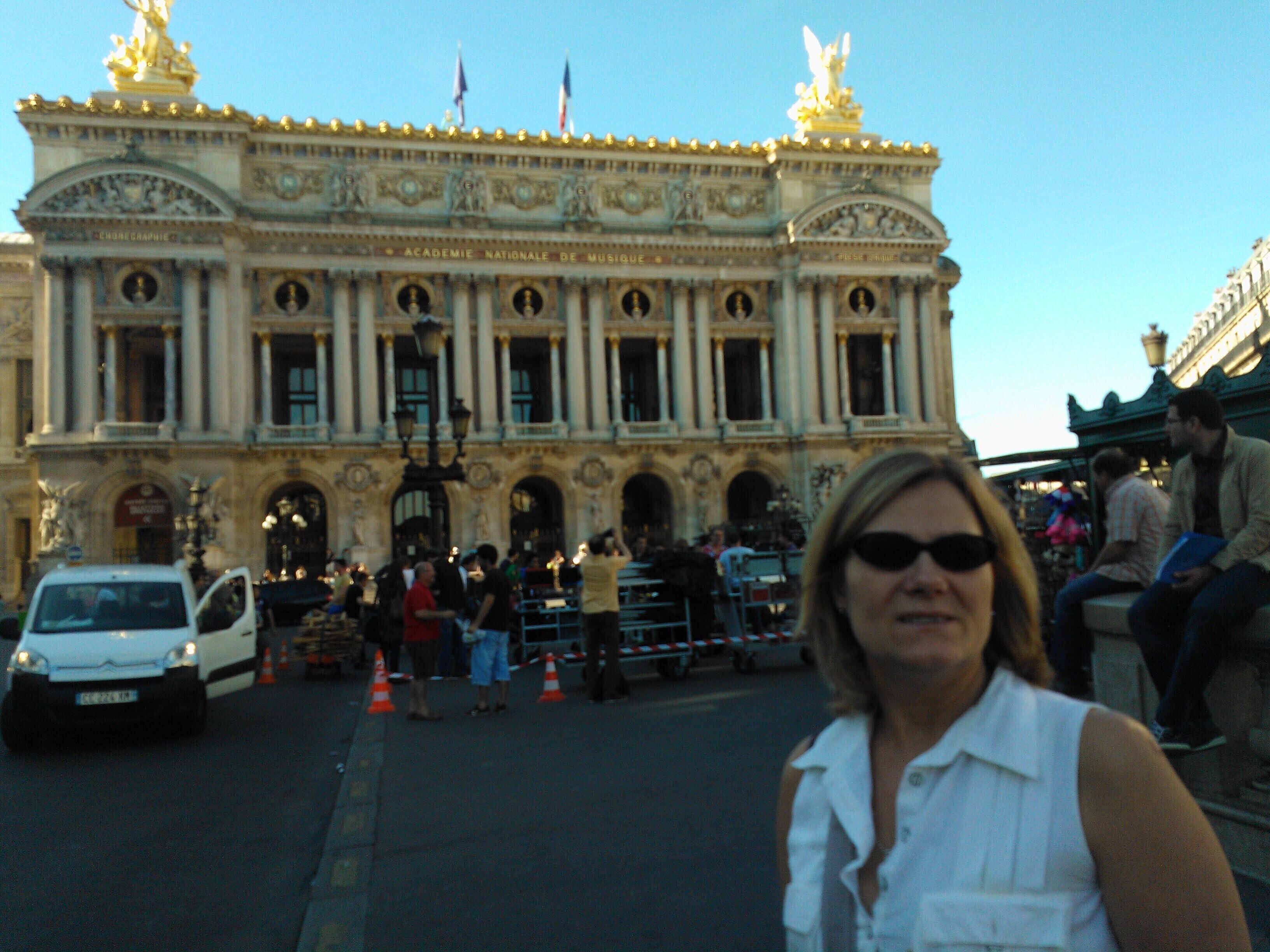 A historic building with classical architecture, including columns and statues.