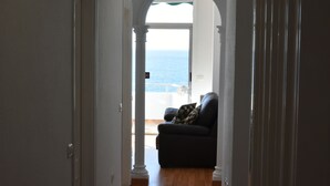 A hallway leading to a balcony with a view of the sea. - The Outside Christians, Fantastic Views. (Arona)