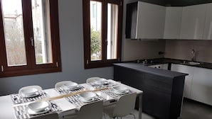 A modern kitchen with a dining area.
