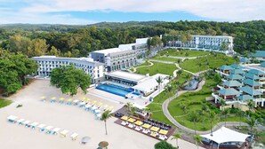 A resort with a swimming pool, multiple buildings, and lush greenery. - Cassia Bintan, part of Banyan Group (Bintan)