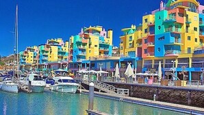 A marina with colorful buildings and boats. - Spacious, well equipped apartment, broadband, Sky TV, with pool just outside. (Albufeira)