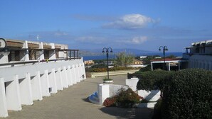 A rooftop terrace with a clear view of the sea and distant mountains.