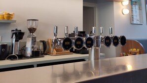 A bar area with a coffee machine and multiple beer taps. - Slo Lyon Saxe (Lyon)