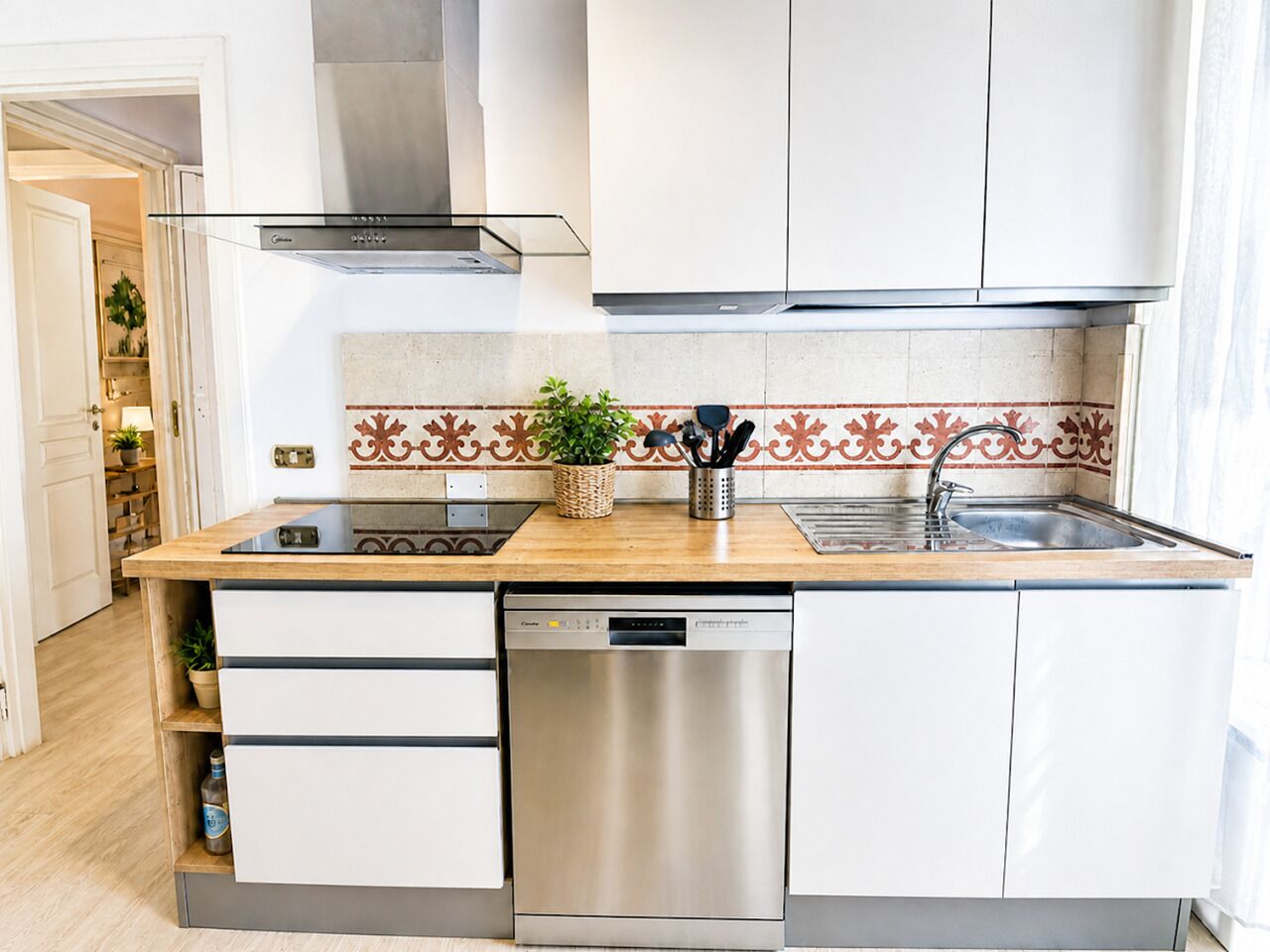 A modern kitchen with a dishwasher, a stove, and a sink.