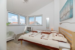 Une chambre à coucher avec un lit, une chaise, une étagère et un tableau.