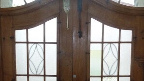A wooden double door with glass panels and a metal handle.