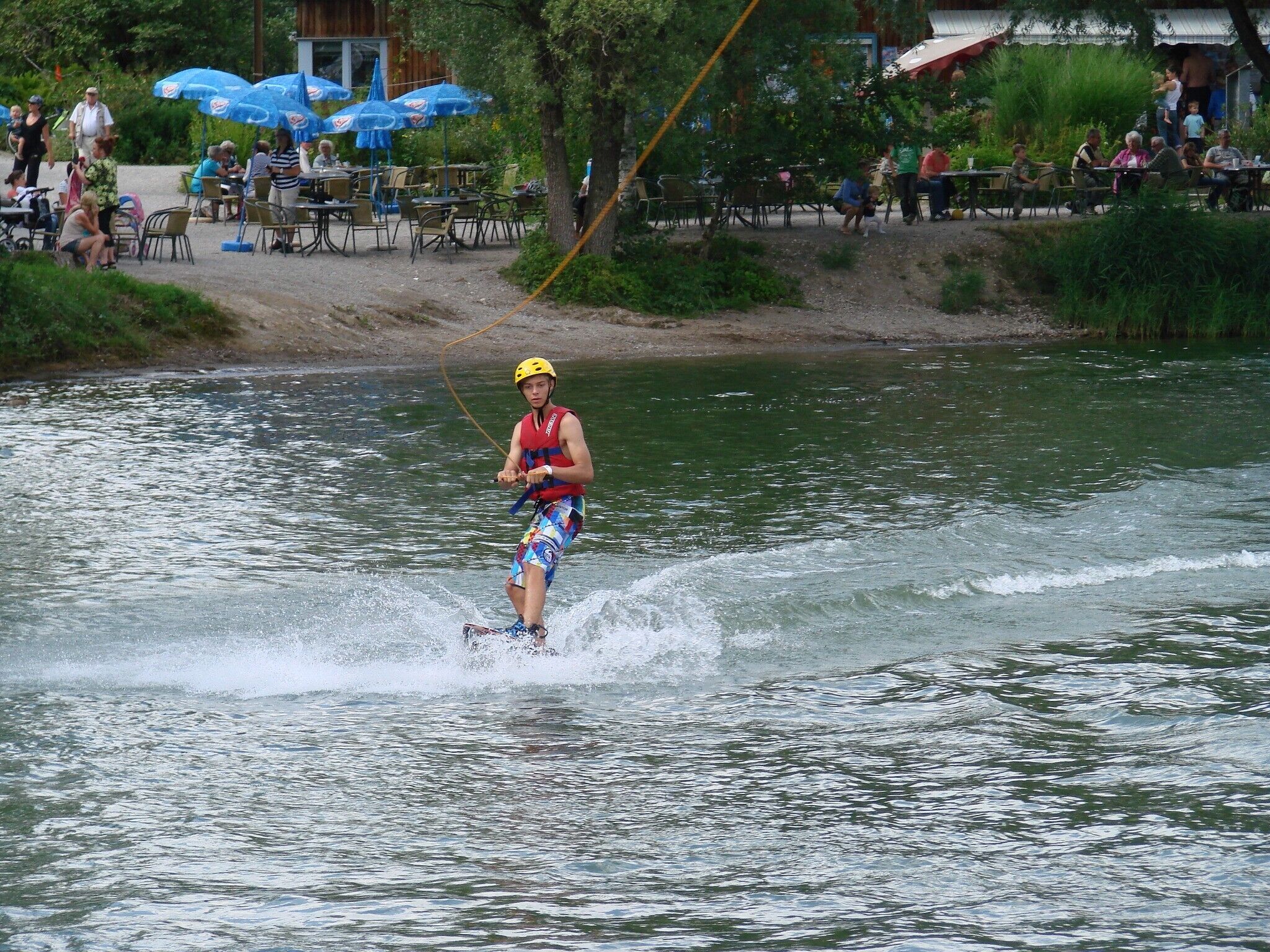 A person water skiing on a river.