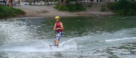 A person water skiing on a river.