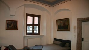 A room with a bed, a window, and two paintings on the walls. - Apartment in historic surroundings (Müglitztal)