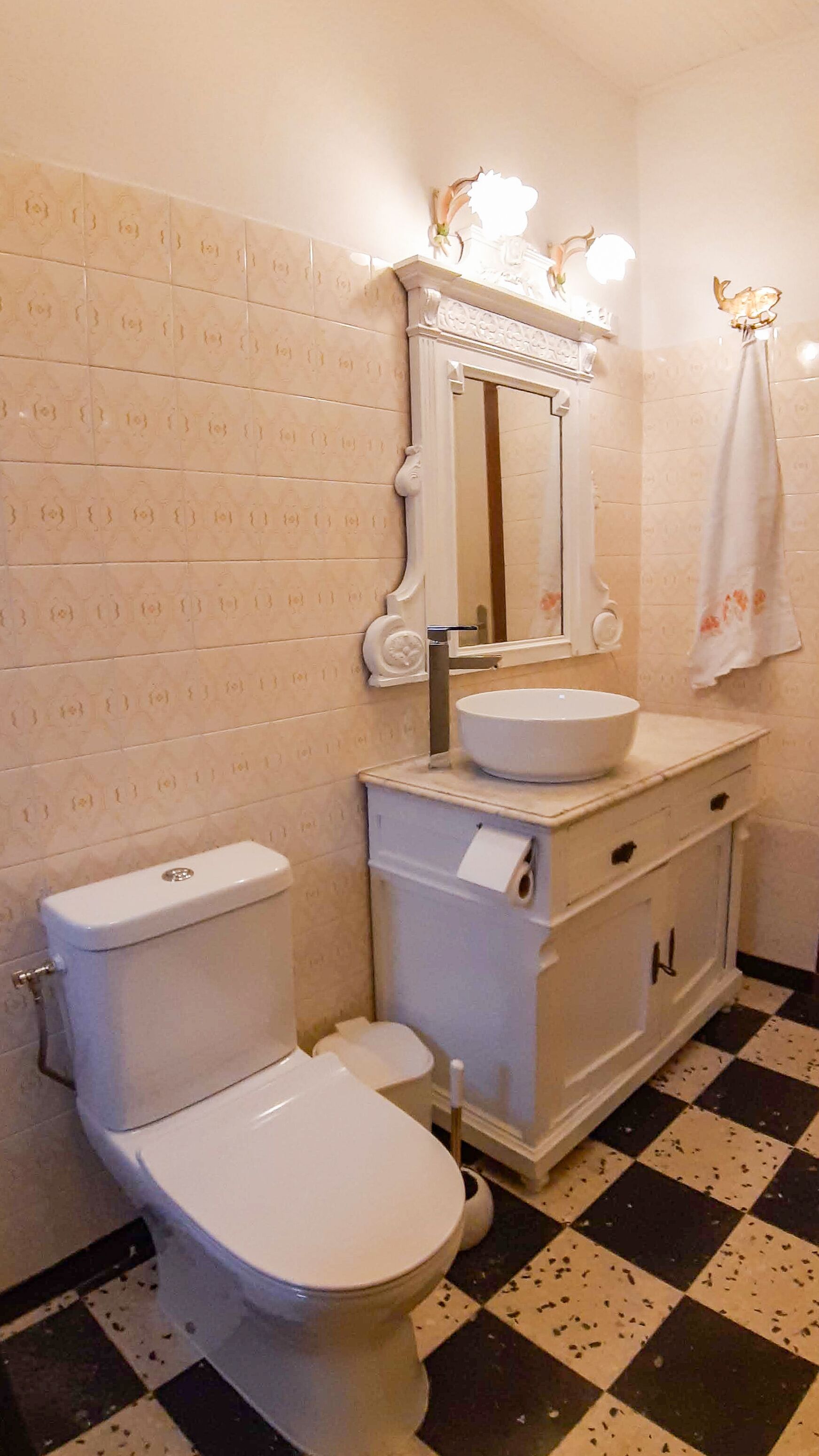 Ein Badezimmer mit Toilette, Waschbecken und Spiegel.
