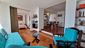 A modern living room with a sofa, chairs, a coffee table, and a dining area with a table and chairs. - MALECÓN BALTA: best location, friendly service, clean & comfortable, safe (Miraflores)
