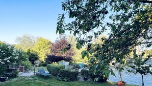 A well-maintained garden with a lawn, various shrubs, and a small tree. - Welcome to the Oderbruch (Wriezen)