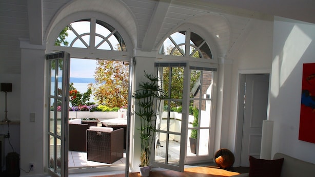 Un espace de vie ouvert donnant sur un patio et un mobilier d’extérieur.