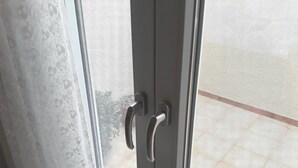 A door with a metal handle and a textured glass panel. - In the narrow streets of the old town, family-friendly, close to the beach (Ierapetra)