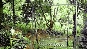 A garden with a metal bench surrounded by greenery and potted plants. - Curr. M.Flair, quiet location, grGarten directly to Forest / Grassland, gr. Lake at 2km, (Blankenheim-Reetz)