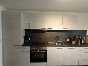 Fridge, stovetop, dishwasher, coffee/tea maker