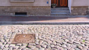 A building with a stone facade, two windows, and a wooden door. - Apartment 'Am Poeler Tor' in the old town of Wismar (Wismar)