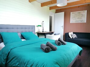 Relax in this inviting space with a large bed, sofa, and side table, perfect for unwinding.