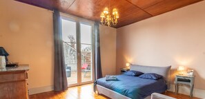 A bedroom with a bed, a nightstand, a dresser, and a sliding glass door leading to an outdoor area. - Large atypical charming house entirely renovated. (Jonzac)
