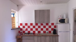 A compact kitchen with a gas stove, a microwave, and a refrigerator. - 2 - Exotic Bungalow T2 & Large Garden near beach  (LA TRINITE)