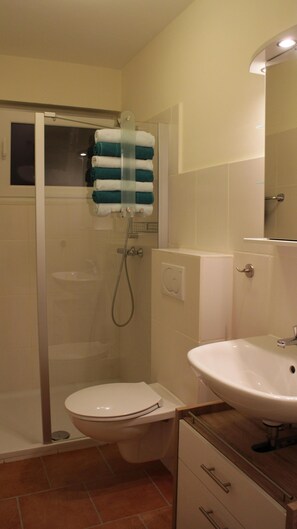 Shower, hair dryer, towels, toilet paper
