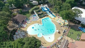 An aerial view of a resort with a large swimming pool, multiple water slides, and sun loungers. - Mobilhome family 6/7 Persons (Saint-Brevin-Les-Pins)