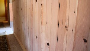 A wooden wall with visible nail holes, suggesting recent construction or repair work. - Near everything. Surrounded by parks, and trails. Sleeps 6. Basecamp for Montana (Bozeman)