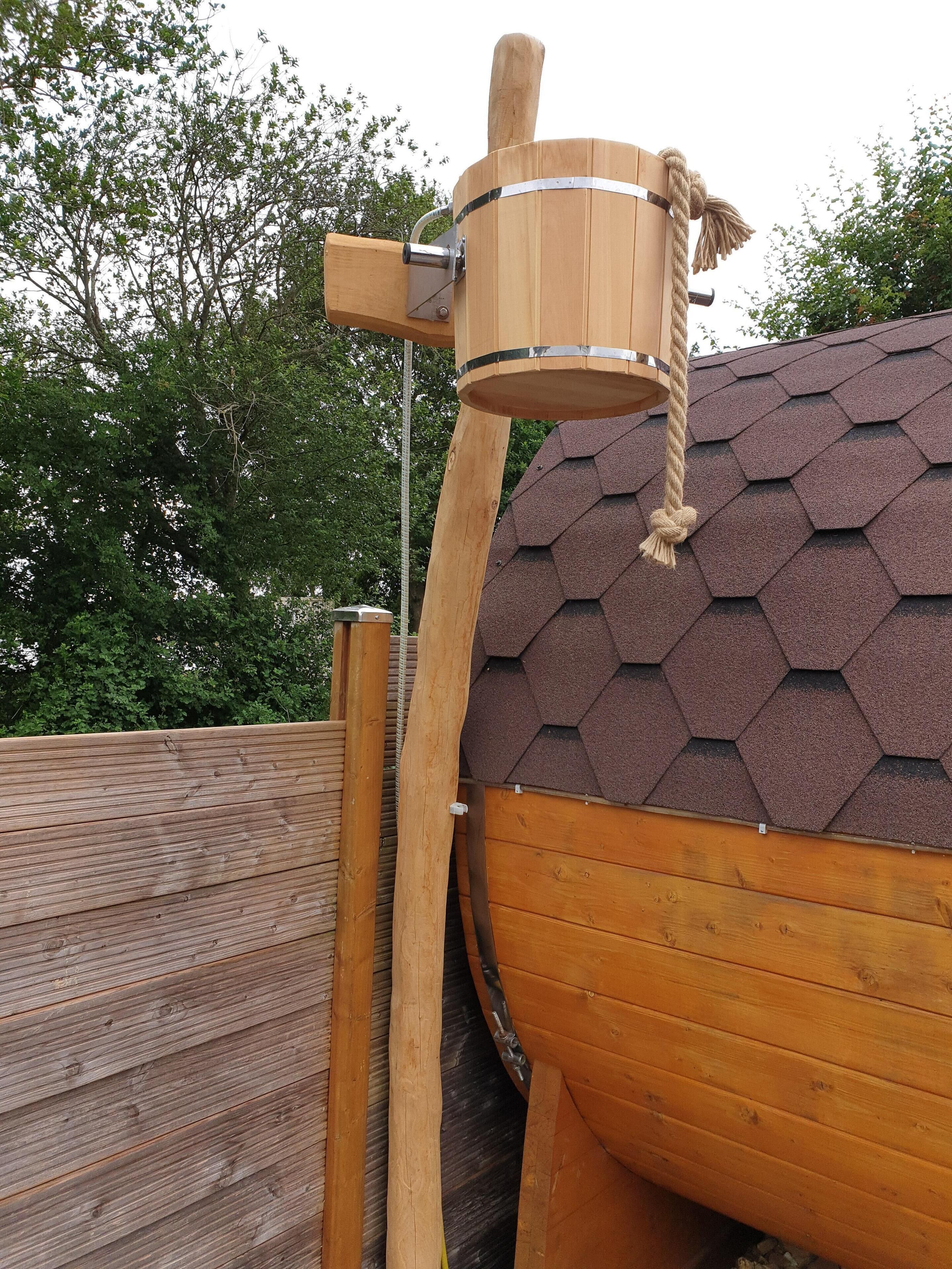 A wooden structure with a rope mechanism, possibly a swing or a climbing feature, attached to a hexagonal roof.